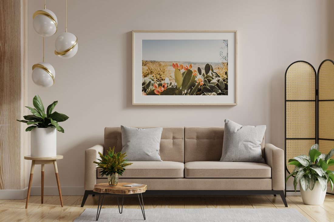 living room with a photo of a cactus in a natural wood wall frame